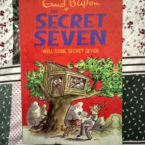 Used Book - Enid Blyton - Well Done Secret Seven - Hachette India - Well Done Secret Seven is a masterstroke of atmospheric mystery. When a simple search for a lost cat leads to a sinister conspiracy in an old, dark house, Blyton ramps up the tension. It’s an invigorating tale of persistence and pluck that teaches kids the power of keen observation.