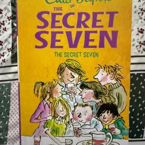 Used Book - Enid Blyton - The Secret Seven - Hachette India - praise this book in 50 words - Enid Blyton - The Secret Seven - Hachette India - Enid Blyton’s The Secret Seven is a masterclass in juvenile mystery. With their secret password and garden shed headquarters, Peter and his team turn every day into a high-stakes adventure. It perfectly captures the magic of childhood teamwork, offering accessible, fast-paced thrills that remain a timeless gateway to reading.