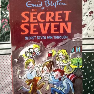 Used Book - Enid Blyton - Secret Seven Win Through - Hachette India - In Secret Seven Win Through, Blyton delivers a thrilling lesson in resilience. After losing their shed, the group finds a spectacular new cave headquarters, only to discover they aren’t alone. It’s a superb tale of territorial intrigue, blending cozy atmosphere with a satisfying payoff that rewards the Seven's trademark persistence.