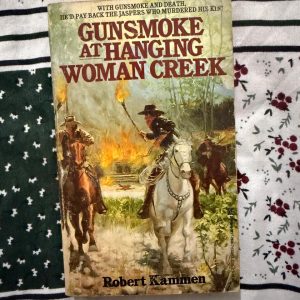 Used Book - Gunsmoke At Hanging Women Creek - Robert Kammen - Gunsmoke At Hanging Woman Creek is a masterclass in classic Western storytelling. Robert Kammen delivers a gritty, action-packed tale of survival, vengeance, and raw frontier justice. With razor-sharp pacing, vivid landscapes, and unforgettable characters, this hard-hitting novel perfectly captures the untamed spirit of the Old West. A thrilling must-read.