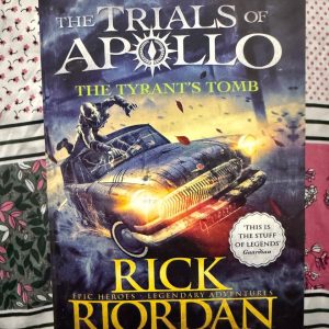 Second Hand Book - The Tyrant's Tomb - Rick Riordan - Epic World - Legendary Adventures - Return To Percy Jackson's World - The Trials of Apollo - The Tyrant's Tomb is a breathtaking, high-stakes triumph in Rick Riordan’s The Trials of Apollo series. Returning to Percy Jackson’s legendary world, this epic adventure brilliantly blends harrowing Roman battles with laugh-out-loud humor and heartbreaking sacrifice. Apollo’s masterful evolution from arrogant deity to true hero makes this a thrilling, unforgettable must-read.