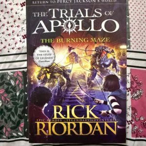 Second Hand Book - The Burning Maze - Rick Riordan - Epic World - Legendary Adventures - Return To Percy Jackson's World - The Trials of Apollo - The Burning Maze is a masterfully tense and emotional triumph in Rick Riordan’s The Trials of Apollo series. Blending trademark mythological wit with heart-pounding danger, it forces Apollo to confront devastating stakes and heartbreaking sacrifice. This epic, fast-paced adventure permanently reshapes Percy Jackson’s legendary universe, making it an unputdownable, unforgettable read.