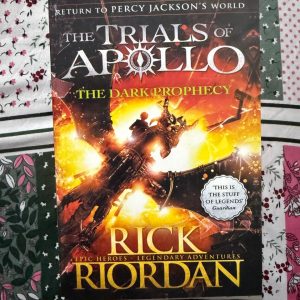 Second Hand Book - The Dark Prophecy - Rick Riordan - Epic World - Legendary Adventures - Return To Percy Jackson's World - The Trials of Apollo - The Dark Prophecy is a thrilling, fast-paced triumph that brilliantly expands Rick Riordan’s The Trials of Apollo series. Packed with mythological monsters, ancient prophecies, and laugh-out-loud humor, it perfectly balances high-stakes danger with heartfelt growth. This spectacular return to Percy Jackson’s legendary world is an absolute, action-packed must-read.