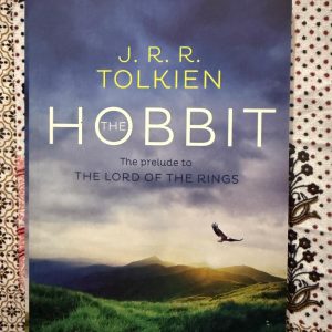 Second Hand Book - J.R.R. Tolkien - The Hobbit - The Prelude to The Lord of the Rings - An absolute masterpiece of fantasy, The Hobbit is a whimsical yet profoundly moving journey of self-discovery. J.R.R. Tolkien’s rich world-building, delightful wit, and timeless themes of courage and unexpected heroism turn Bilbo Baggins' grand adventure into an enchanting, unforgettable prelude that lays the magnificent foundation for middle-earth mythology.