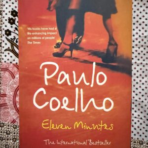 Used Book - Paulo Coelho - Eleven Minutes - A deeply honest and poetic exploration of love and desire, Eleven Minutes masterfully navigates the delicate intersection of sacred and profane passion. Paulo Coelho treats a taboo subject with immense dignity, transforming a young woman's journey of self-discovery into a profound, soul-stirring awakening of the true nature of intimacy and inner freedom.