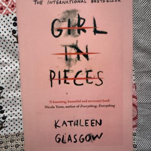 Used Book - Girl In Pieces - Kathleen Glasgow - Girl in Pieces is a breathtakingly raw, deeply moving portrait of trauma, survival, and resilience. Kathleen Glasgow captures Charlie’s journey through the darkest depths of self-harm and heartbreak with profound empathy and unflinching honesty. It is an unforgettable, beautifully written testament to the painful, beautiful process of putting oneself back together.