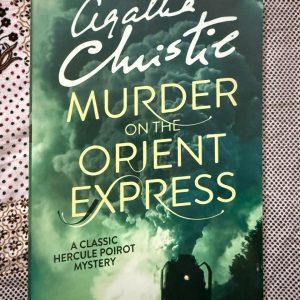 Used Book - Agatha Christie - The Murder On The Orient Express - A Classic Hercule Poirot Mystery - Agatha Christie’s masterpiece is the ultimate locked-room mystery. Trapped in a snowdrift, the glamorous Orient Express becomes a pressure cooker of suspense. Hercule Poirot's brilliant deductions turn a seemingly impossible crime into a psychological chess match. With its legendary, jaw-dropping twist ending, it remains an absolute triumph of detective fiction.