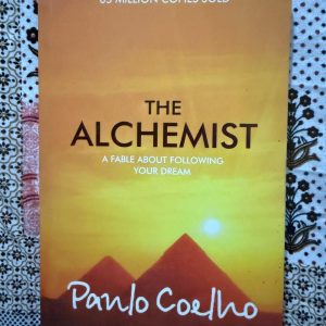 Used Book - Paulo Coelho - The Alchemist - A Fable About Following Your Dream - An enchanting and globally cherished masterpiece, The Alchemist is a profoundly moving fable about the magic of listening to your heart. Paulo Coelho’s poetic wisdom beautifully illustrates that when you courageously pursue your personal legend, the universe conspires to help you. It remains an unforgettable, soul-stirring testament to hope and destiny.
