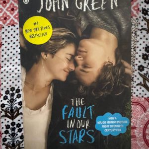 Used Book - The Fault In Our Stars - John Green - The Fault in Our Stars is a devastatingly beautiful, witty, and profoundly moving masterpiece. John Green brilliantly captures the raw complexity of young love facing mortality, avoiding cheap sentimentality for unflinching honesty. Hazel and Augustus’s story is a humorous, heartbreaking, and unforgettable exploration of what it truly means to be alive.