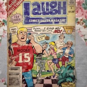 Used Book - LAUGH Comics Digest Magazine - Laugh is a hilarious tribute to Riverdale’s premier burger-loving nonconformist. Bursting with classic adventures, crown-wearing antics, and his trademark sarcastic wit, this pocket-sized powerhouse delivers double the laughs. It is a delightfully charming read that perfectly celebrates the ultimate lazy genius and his timeless comic escapades.