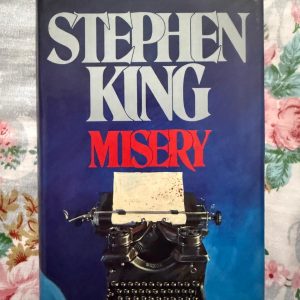 Second Hand Book - Stephen King - MISERY - Stephen King’s Misery is a claustrophobic psychological masterpiece that brilliantly explores the terrifying dark side of fandom. Capturing the agonizing battle of wits between a captive novelist and his psychotic "number one fan," Annie Wilkes, King delivers a taut, visceral thriller about obsession, isolation, and the agonizing price of creativity.