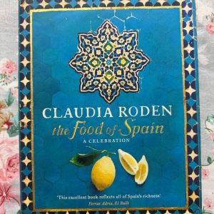 Used Book - Claudia Roden - The Food of Spain - A Celebration - Claudia Roden’s The Food of Spain is a monumental masterpiece that masterfully blends vibrant culinary history with foolproof recipes. Celebrating the rich, diverse tapestry of Spanish gastronomy, Roden’s passionate storytelling and profound research transport readers straight to the Iberian peninsula. It is an indispensable, breathtaking treasure for every food lover's library.