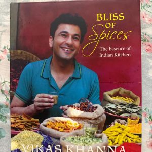 Used Book - Bliss of Spices - The Essence of Indian Kitchen - Vikas Khanna - Vikas Khanna’s Bliss of Spices is a sensory masterpiece that brilliantly captures the soul of Indian culinary heritage. Celebrating the rich tapestry and health benefits of traditional spices, Khanna’s evocative storytelling and vibrant recipes transform everyday cooking into an art form. It is a breathtaking, indispensable treasure for every kitchen.