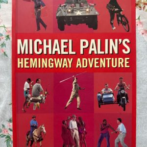 Used Book - MICHAEL PALIN - Hemingway Adventure - Seven Dials - In Hemingway’s Adventure, Michael Palin delivers a masterful blend of travelogue and biography. Retracing Ernest Hemingway’s footsteps across the globe with his signature wit and keen observation, Palin breathes vibrant new life into the legendary author's exploits—making it an exhilarating, deeply insightful read for adventure lovers and literary fans alike.