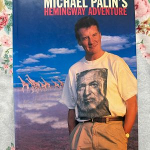 Used Book - MICHAEL PALIN - Hemingway Adventure - Weidenfeld & Nicolson - In Hemingway’s Adventure, Michael Palin delivers a masterful blend of travelogue and biography. Retracing Ernest Hemingway’s footsteps across the globe with his signature wit and keen observation, Palin breathes vibrant new life into the legendary author's exploits—making it an exhilarating, deeply insightful read for adventure lovers and literary fans alike.
