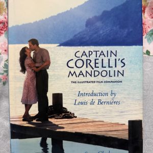 Used Book - Captain Corelli's Mandolin - The Illustrated Film Companion - Introduction by Louis De Bernieres - Steve Clark - madaboutbooks.com - This illustrated companion offers a stunning behind-the-scenes look at the cinematic adaptation of Captain Corelli's Mandolin. Featuring a personal introduction by Louis de Bernières and expert insights from Steve Clark, it beautifully combines vivid film photography with exclusive production details, making it a must-have treasure for fans of the story.
