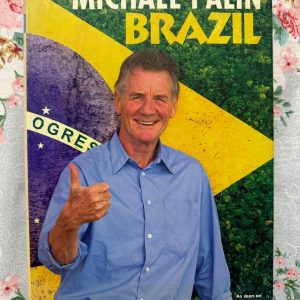 Used Book - MICHAEL PALIN - Brazil - As Seen on BBC - Orion Books (Hardbound) - In Brazil, Michael Palin delivers a vibrant, captivating journey through a sprawling nation of contrasts. Tied to the acclaimed BBC series, Palin’s trademark warmth, curiosity, and sharp wit bring Brazil’s diverse landscapes, rich culture, and dynamic people to brilliant life—offering an unforgettable, deeply engaging travel companion for any adventurer.