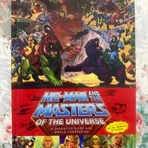 Used Book - HE-MAN - And The Masters Of The Universe - A Character Guide And World Compendium - Also Featuring She-Ra, Princess of Power - Hardbound - *He-Man and the Masters of the Universe: A Character Guide and World Compendium* is an extraordinary hardcover masterpiece. Featuring both Eternia and She-Ra's Etheria, this stunning volume overflows with gorgeous illustrations, rich lore, and exhaustive character histories. An absolute, nostalgia-fueled treasure every fan needs on their shelf!